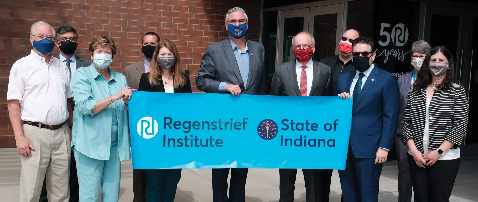 Indiana Governor Eric Holcomb presents award to Regenstrief team