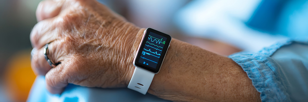 closeup of an elderly patient's arm with a vitals tracking wristband